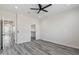 Bright bedroom with gray wood-look flooring and an overhead ceiling fan at 1642 E Monte Vista Rd # 10, Phoenix, AZ 85006