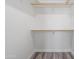 Bright walk-in closet with built-in shelves and light gray wood-look flooring at 1642 E Monte Vista Rd # 10, Phoenix, AZ 85006