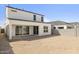 A large backyard featuring a covered patio with an outer brick fence and open space for landscaping at 17837 W Mission Ln, Waddell, AZ 85355