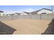 A large backyard features an outer brick fence and open space for future landscaping at 17837 W Mission Ln, Waddell, AZ 85355