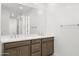 Bathroom featuring a double vanity with marble countertops, cabinets, and large mirrors at 17837 W Mission Ln, Waddell, AZ 85355