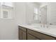 Bathroom vanity featuring dual sinks, stone countertop and wood cabinets at 17837 W Mission Ln, Waddell, AZ 85355