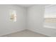 This bedroom has neutral carpet and paint, and two windows offering natural light at 17837 W Mission Ln, Waddell, AZ 85355