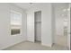 This bedroom features neutral carpet, access to the closet, and a window that offers natural light at 17837 W Mission Ln, Waddell, AZ 85355