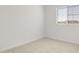 This bedroom has neutral carpet and paint, and a window offering natural light at 17837 W Mission Ln, Waddell, AZ 85355