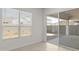 Bright bedroom with window and sliding glass door that leads to backyard patio at 17837 W Mission Ln, Waddell, AZ 85355