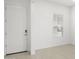 Inviting entryway with white door and walls, light tile flooring, and ample natural light at 17837 W Mission Ln, Waddell, AZ 85355