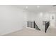 Hallway featuring black railing, neutral carpet, recessed lighting, and white doors at 17837 W Mission Ln, Waddell, AZ 85355