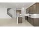 Spacious kitchen with large island, stainless steel appliances, and dark wood cabinets; open concept design at 17837 W Mission Ln, Waddell, AZ 85355