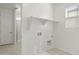 Bright laundry room featuring window, tile floor and shelving for storage at 17837 W Mission Ln, Waddell, AZ 85355