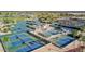 Aerial view of well maintained tennis courts with lush landscaping in a well designed layout at 18522 N Mica Dr, Sun City West, AZ 85375