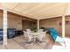 Charming covered patio area with plenty of seating, perfect for entertaining or enjoying a peaceful afternoon at 18522 N Mica Dr, Sun City West, AZ 85375
