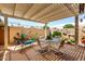 Inviting back patio area, perfect for outdoor dining and relaxation with a pergola and comfortable seating at 18522 N Mica Dr, Sun City West, AZ 85375