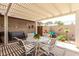 Charming covered patio area with plenty of seating, perfect for entertaining or enjoying a peaceful afternoon at 18522 N Mica Dr, Sun City West, AZ 85375