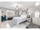 Bright bedroom with a ceiling fan, bench and a bed with white bedding at 18522 N Mica Dr, Sun City West, AZ 85375