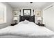Bright bedroom with plush white bedding, stylish lamps, and neutral tones at 18522 N Mica Dr, Sun City West, AZ 85375