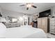 Bedroom with ceiling fan, white bedding, and light colored furniture at 18522 N Mica Dr, Sun City West, AZ 85375
