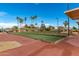 Outdoor bocce ball courts with shading, seating, and landscaping offer an opportunity for recreation in a community setting at 18522 N Mica Dr, Sun City West, AZ 85375