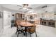 Open-concept dining area with tile floors, stylish furnishings, and natural light at 18522 N Mica Dr, Sun City West, AZ 85375