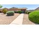Charming single-story home with a well-maintained, zero-scaped front yard and inviting walkway to the front door at 18522 N Mica Dr, Sun City West, AZ 85375