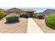 Inviting home exterior with rock landscaping and a quaint seating area near the front door at 18522 N Mica Dr, Sun City West, AZ 85375