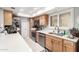Modern kitchen featuring stainless steel appliances, white countertops, and ample cabinet space at 18522 N Mica Dr, Sun City West, AZ 85375