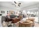 Cozy living room with a leather sofa, patterned chairs, and sliding glass doors for natural light at 18522 N Mica Dr, Sun City West, AZ 85375