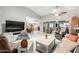Bright open-concept living area featuring tile floors, natural light and easy access to other living areas at 18522 N Mica Dr, Sun City West, AZ 85375
