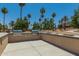 Well-equipped outdoor kitchen area with built-in grill and lush greenery, perfect for entertaining guests at 18522 N Mica Dr, Sun City West, AZ 85375