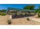 Charming picnic area with shaded tables, green grass, and desert flowers create a refreshing outdoor space at 18522 N Mica Dr, Sun City West, AZ 85375