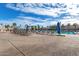 A swimming pool and sunbathing area is equipped with lounge chairs and umbrellas, providing a perfect spot for rest and relaxation at 18522 N Mica Dr, Sun City West, AZ 85375