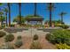 Welcoming Sun City West sign surrounded by lush landscaping and blooming flowers, creating an inviting entrance at 18522 N Mica Dr, Sun City West, AZ 85375