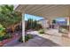 Covered patio with desert landscaping, a storage shed, and a lush array of trees and plants at 1855 N Rim Rock Dr, Casa Grande, AZ 85122