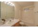 Bright bathroom featuring a shower-tub combo, single sink vanity, and well-lit mirror with decorative light fixture at 1855 N Rim Rock Dr, Casa Grande, AZ 85122