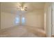 Spacious bedroom with a ceiling fan and natural light, providing a welcoming and airy atmosphere for relaxation at 1855 N Rim Rock Dr, Casa Grande, AZ 85122