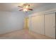 Cozy bedroom boasts a ceiling fan, closet with sliding doors, and an adjoining room creating a spacious and functional layout at 1855 N Rim Rock Dr, Casa Grande, AZ 85122
