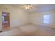 Bedroom with a ceiling fan and two windows, leading to another room, and creating a comfortable and accessible living space at 1855 N Rim Rock Dr, Casa Grande, AZ 85122
