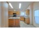 Charming kitchen featuring wooden cabinetry, center island, and modern appliances at 1855 N Rim Rock Dr, Casa Grande, AZ 85122