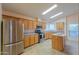 Modern kitchen with stainless steel refrigerator, ample cabinets, and eat-in island at 1855 N Rim Rock Dr, Casa Grande, AZ 85122