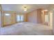 Spacious living room featuring carpet, ceiling fan, and natural light from windows at 1855 N Rim Rock Dr, Casa Grande, AZ 85122
