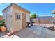 Exterior of a tan storage shed with a window and door, situated on a concrete slab at 1855 N Rim Rock Dr, Casa Grande, AZ 85122