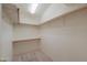 Spacious walk-in closet with ample shelving and carpet, offering plenty of storage and organization options at 1855 N Rim Rock Dr, Casa Grande, AZ 85122