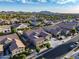 Well-planned community with attractive homes, green spaces, and streetscapes from an elevated aerial perspective at 21283 E Camacho Rd, Queen Creek, AZ 85142