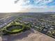 Expansive aerial view of the community showcasing lush green spaces and well-maintained homes at 21283 E Camacho Rd, Queen Creek, AZ 85142