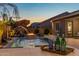 Backyard view featuring a refreshing pool, fire pit, and outdoor dining, perfect for entertaining guests at 21283 E Camacho Rd, Queen Creek, AZ 85142