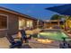 Outdoor living space with a pool, bar, fire pit and patio seating area at 21283 E Camacho Rd, Queen Creek, AZ 85142