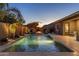 Inviting backyard oasis featuring a sparkling pool, fountain features, and relaxing seating areas perfect for outdoor entertaining at 21283 E Camacho Rd, Queen Creek, AZ 85142