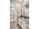 Bathroom with shower stall, large mirror, and white vanity with black hardware at 21283 E Camacho Rd, Queen Creek, AZ 85142