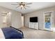 Bedroom with a TV, dresser, and a door to another area at 21283 E Camacho Rd, Queen Creek, AZ 85142