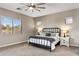 Bedroom with a decorative metal bed frame and carpeted floors at 21283 E Camacho Rd, Queen Creek, AZ 85142